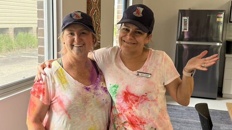 Photo of female principal and deputy principal covered in colour from colour run