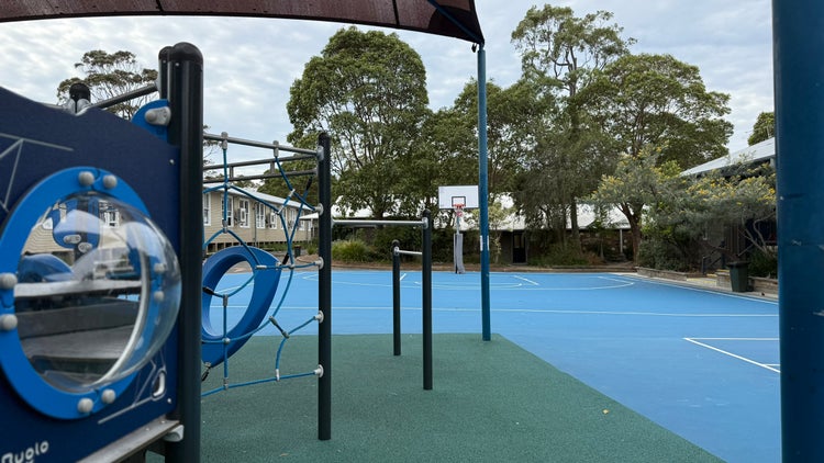 Photo of play equipment and blue basketball court