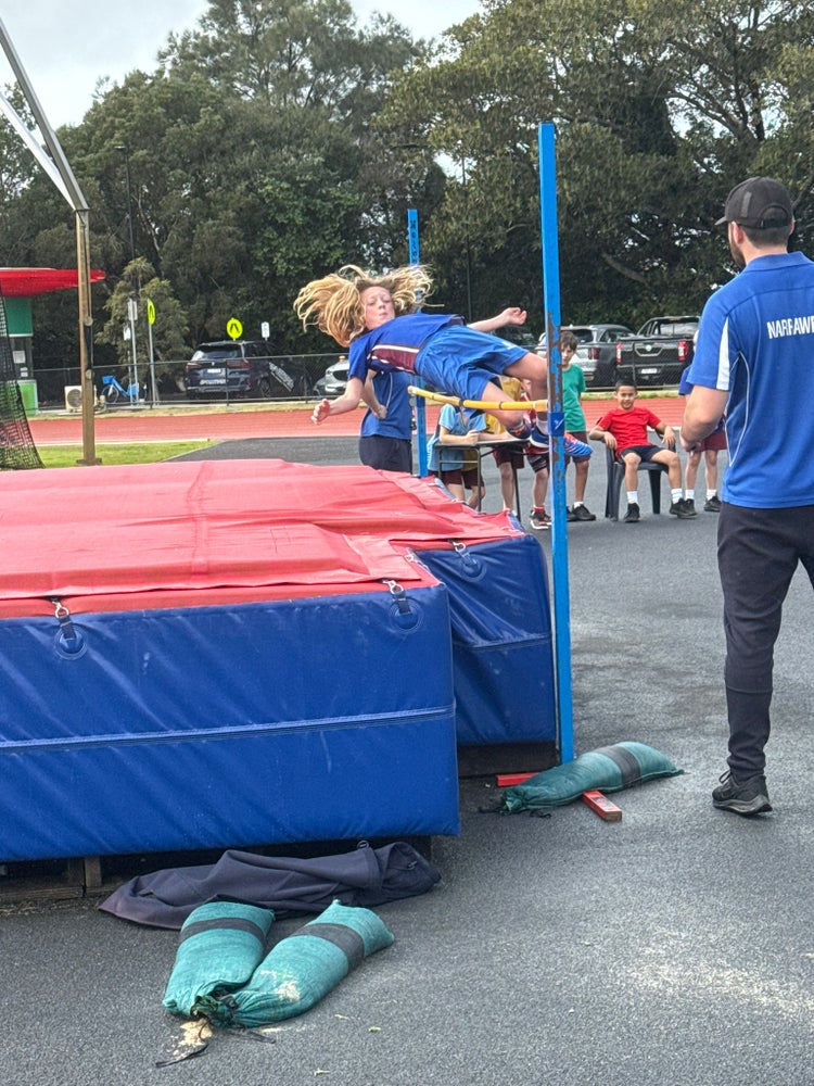 Year 4 male student doing high jump