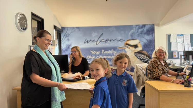 Photo of three female admin team and 2 female students in the school office
