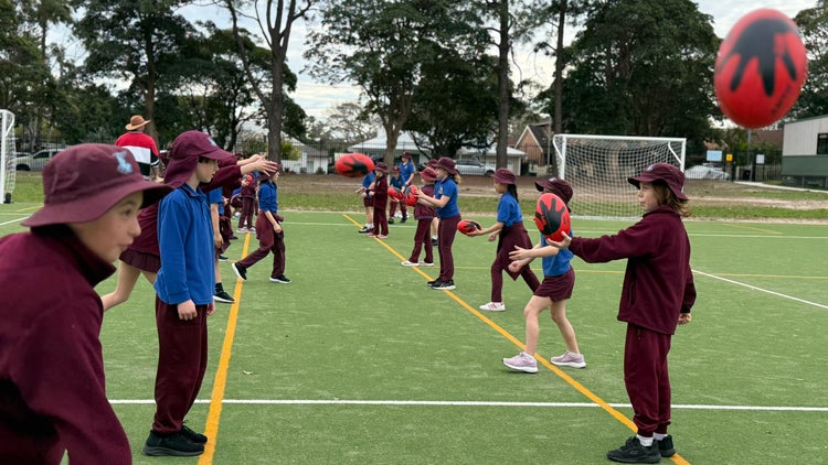 Photo of Year 3 students learning how to catch football