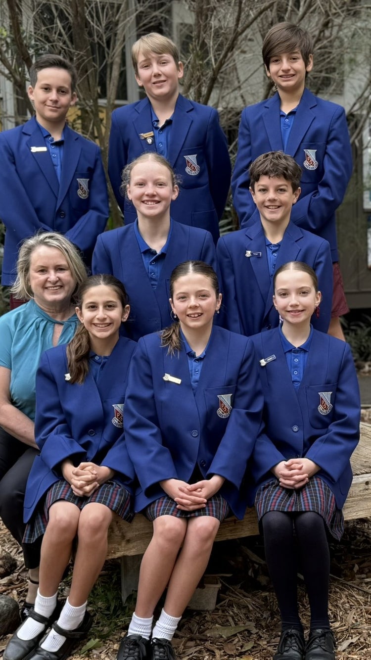 Photo of school principal with 4 male and 4 female student leaders